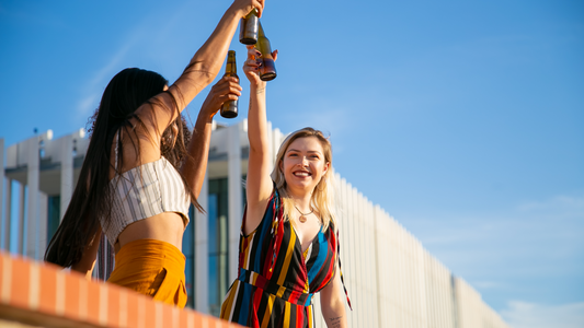 Three women cheers-ing with each other