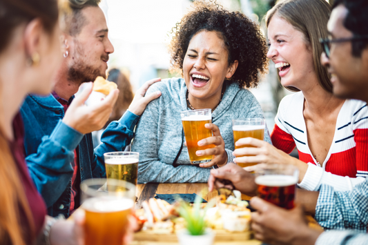 A group of friends laughing and drinking beer